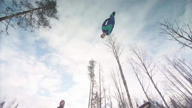 SLOW MOTION - Teeterboarders performing backflips and 360 degree twists