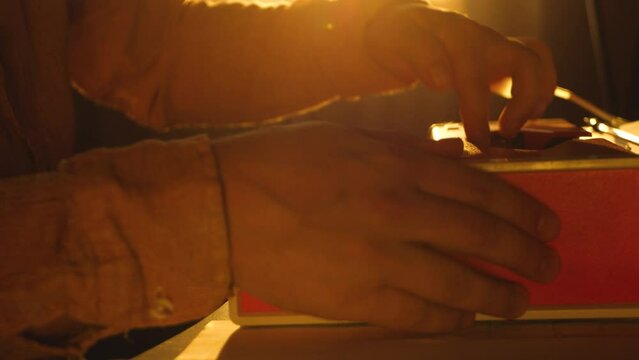 Male journalist or editor make article in newspaper. Type text on stationary mechanical typewriter on desk in office. Reporter works in media, journalism. Paperwork and typescript