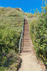 Fototapeta na wymiar Wooden stairs with handrailing on a hill at San Clemente, California