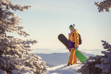 Beautiful young girl with a snowboard