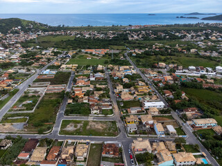Amazing seaside town amidst nature and mountains top view with the sea in the background, drone, Arma&ccedil;&atilde;o de B&uacute;zios, Rio de Janeiro, Brazil