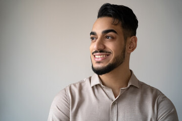 Obraz premium Face portrait of happy indian man looking aside with toothy smile isolated