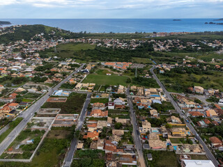 Amazing seaside town amidst nature and mountains top view, drone - Arma&ccedil;&atilde;o de B&uacute;zios, Rio de Janeiro, Brazil