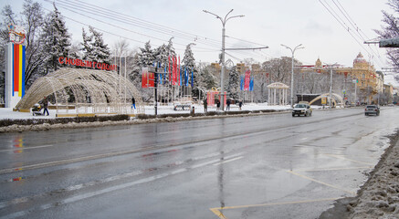  Cars are driving along Bolshaya Sadovaya Street, pedestrians are walking in winter after a snowfall