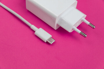 Charger and USB cable type C over red background