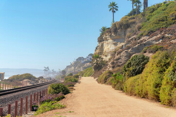 Train track and dirt road at the beach of San Clemente, California - obrazy, fototapety, plakaty