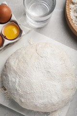 Flat lay composition with dough and ingredients on light grey marble table. Sodawater bread recipe