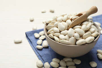 Fototapeta na wymiar Raw beans on white wooden table, closeup. Space for text