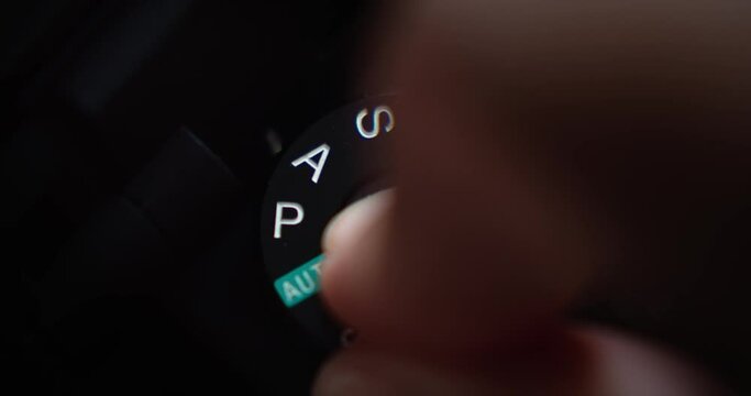 Close up static shot of finger putting camera in manual exposure mode