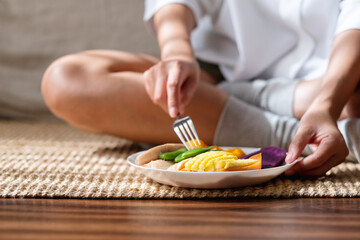 Obraz na płótnie Canvas Closeup image of a woman eating vegetables, Vegan, Clean food, dieting concept