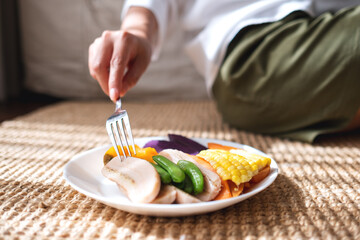 Closeup image of a woman eating vegetables, Vegan, Clean food, dieting concept