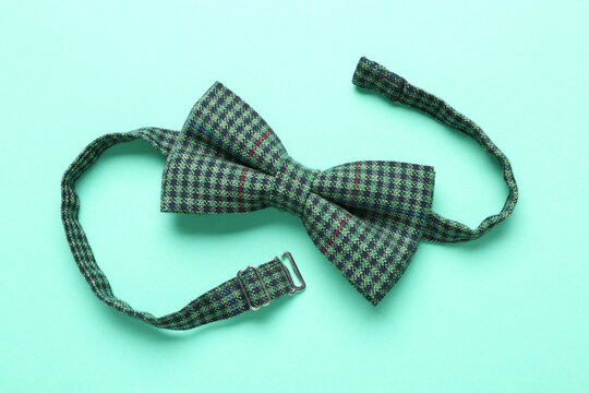 Stylish Gingham Bow Tie On Light Green Background, Top View