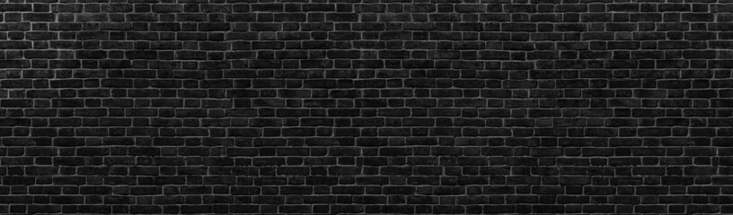 Black brick wall. Texture of old dark brickwork panoramic backgorund.