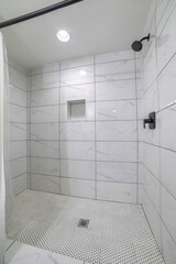 Bathroom interior with marble tiles surround and mosaic tiles flooring