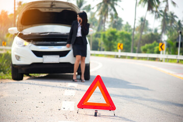 Business woman calling car insurance for assistance broken car on the road, signs Emergency .