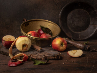 Still life with fruit. Red apples. Peeled apple. Rustic style.