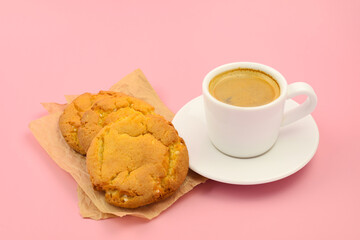 cup of black coffee and homemade cookies on a pink background, coffee and dessert