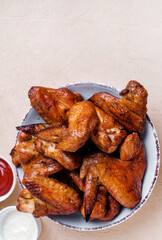 Barbecue chicken wings on wooden table. Top view.
