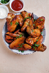 Barbecue chicken wings on wooden table. Top view.