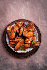 Barbecue chicken wings on wooden table. Top view.