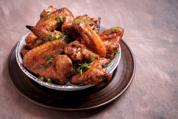 Plate of barbecue chicken wings on wooden table. Top view. copyspace