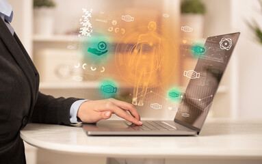 Doctor working on laptop with healthcare concept