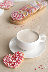 ceramic coffee cup with cookies in the shape of a heart on a light background
