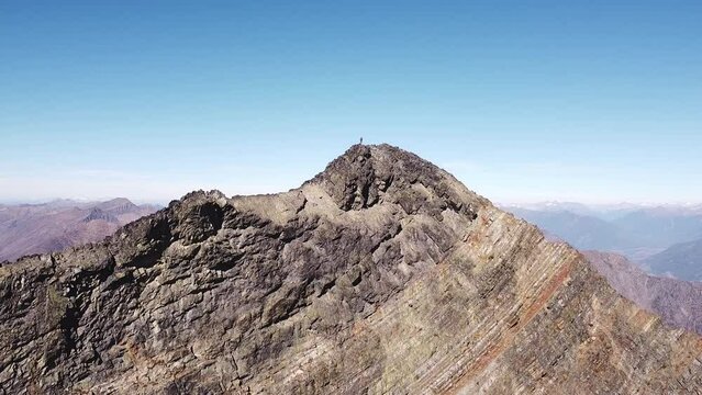 A person standing on the top of the mountain, pedestal shot, Purcell mountains