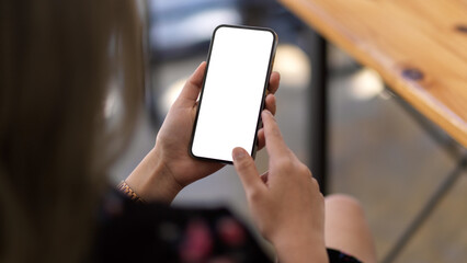 A mockup white screen of cellphone in woman's hand
