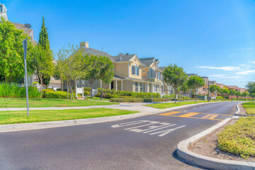 Fototapeta na wymiar Street road with yeld and pedestrian lanes at Ladera Ranch community in California