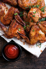 Close up Barbecue chicken wings on rustic wooden table background. Top view. Copy space 