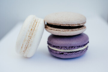 purple gray and white macarons on a white background fresh and delicious dessert