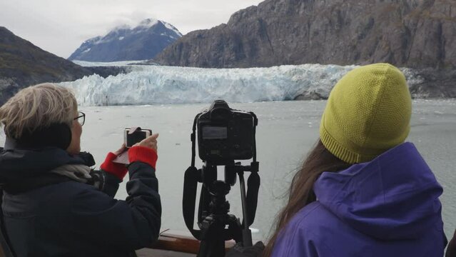 Cruise ship Alaska Glacier Bay Tourists and photographer looking at Margerie Glacier taking pictures on cruise ship taking photos. People on vacation travel cruising famous destination
