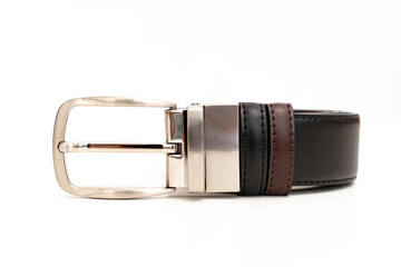 Double-sided black and brown leather belt with an unbuttoned buckle on a white background.