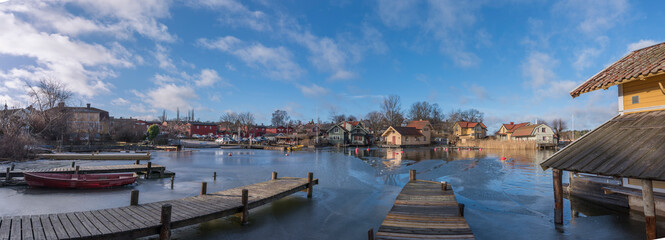 Panorama view over a small bay with summer houses and jetties in the archipelago town Vaxholm a winter day in Stockholm
