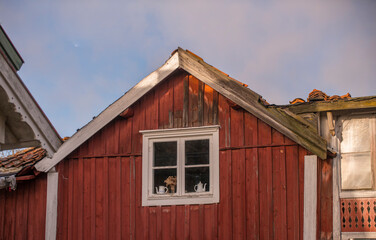 Facade of an abandoned red wood house in the archipelago a winter day in Stockholm