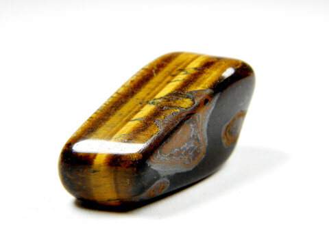 natural mineral gem stone - Tiger's eye (Tigers eye, Tiger eye) gemstone isolated on white background close up