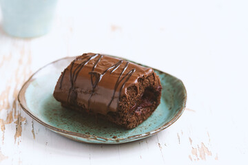 Delicious chocolate roll cake with  icing  and cherry filling. Drunk cherry cake