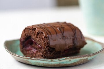 Delicious chocolate roll cake with  icing  and cherry filling. Drunk cherry cake