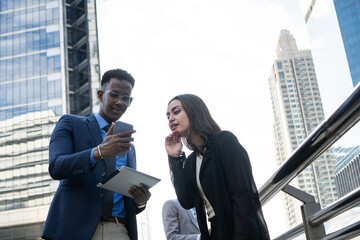 Group of business people.Business people meeting talking and sharing their ideas in city. Business team and teamwork concept. Business people standing outside in the city discussing about new project.