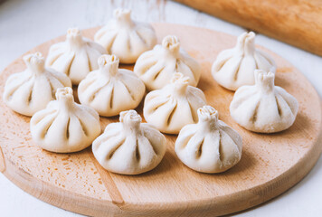 Raw frozen khinkali the kitchen. The process of preparing khinkali. Closeup