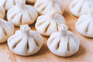 Famous georgian dish meat khinkali uncooked on cutting board with copy space
