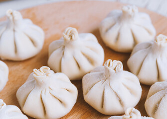Famous georgian dish meat khinkali uncooked on cutting board with copy space
