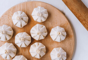 Famous georgian dish meat khinkali uncooked on cutting board with copy space
