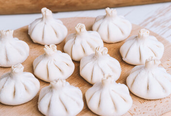 Raw frozen khinkali the kitchen. The process of preparing khinkali. Closeup