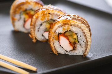 Sushi roll with rice, crab, cucumber, avocado ,tobiko, eel. Sushi menu. Japanese food.
