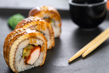 Sushi roll with rice, crab, cucumber, avocado ,tobiko, eel. Sushi menu. Japanese food.