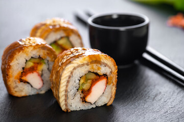 Sushi roll with rice, crab, cucumber, avocado ,tobiko, eel. Sushi menu. Japanese food.