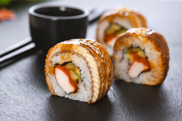 Sushi roll with rice, crab, cucumber, avocado ,tobiko, eel. Sushi menu. Japanese food.