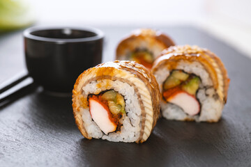 Sushi roll with rice, crab, cucumber, avocado ,tobiko, eel. Sushi menu. Japanese food.